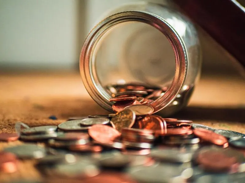 Jar of coins spilled over