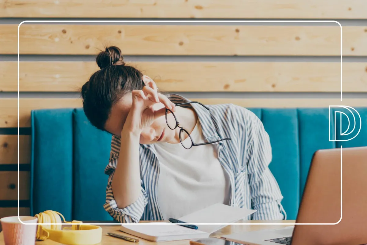 overwhelmed woman with head in hands