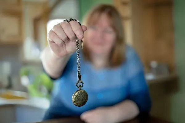 Kathryn Dunn HypnoGirl Holding a Swinging Watch