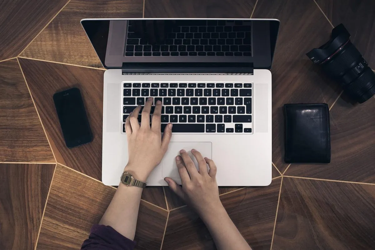 woman writing on a computer