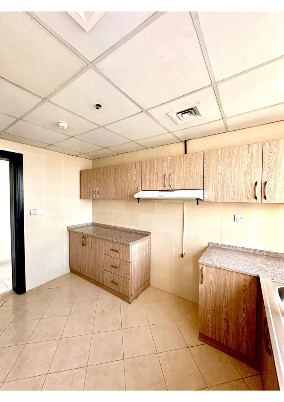 Kitchen photo towards the door for 2 bedroom apt in Khawla Tower