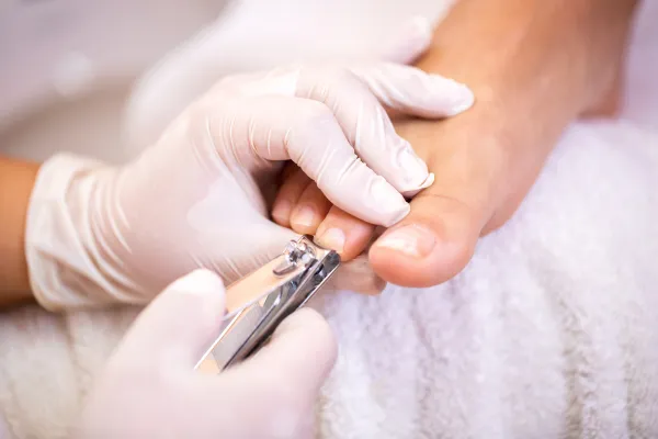 person getting toenails trimmed