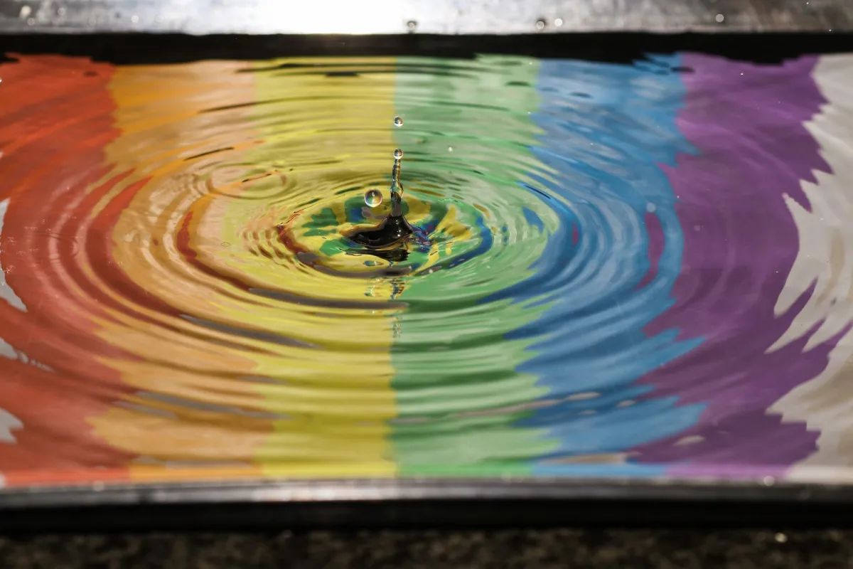 water dropping rainbow reflection