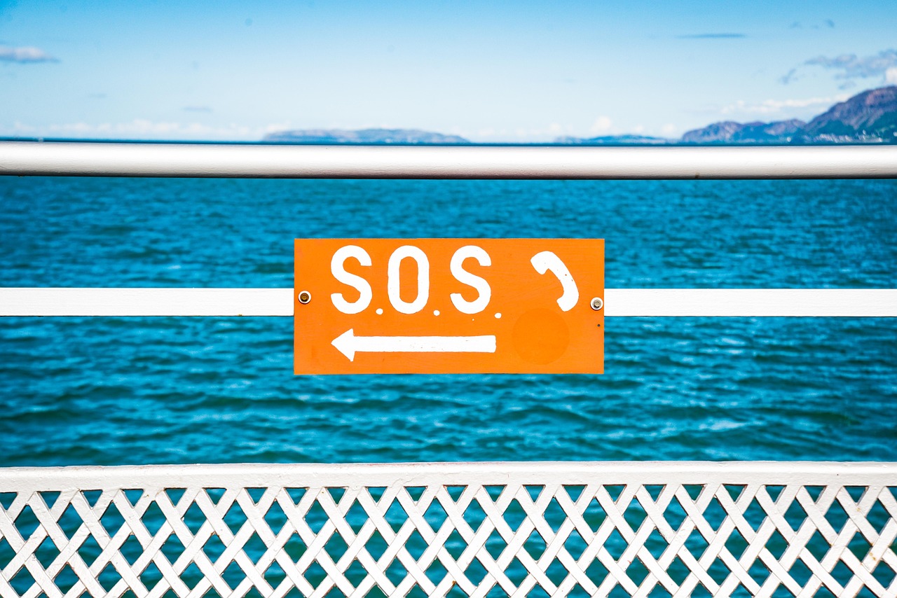 S.O.S. sign pointing to a phone