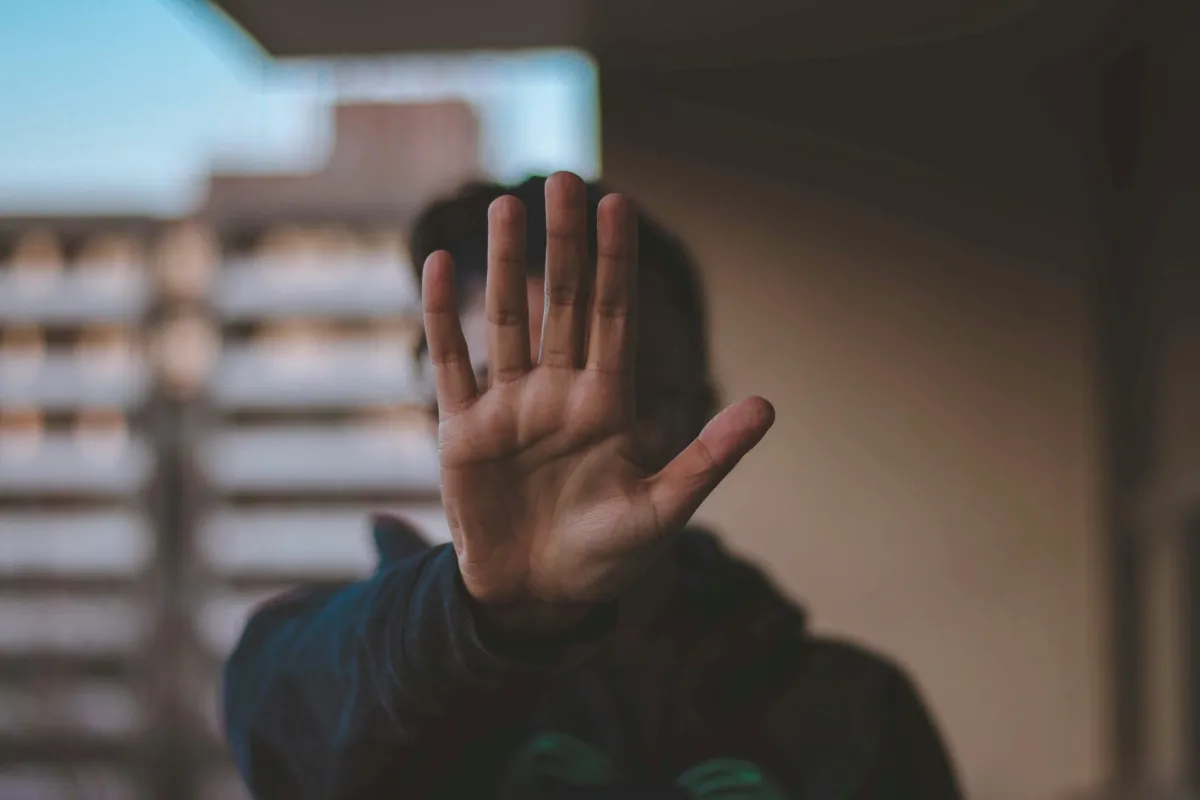 Woman with her hand up in stop gesture