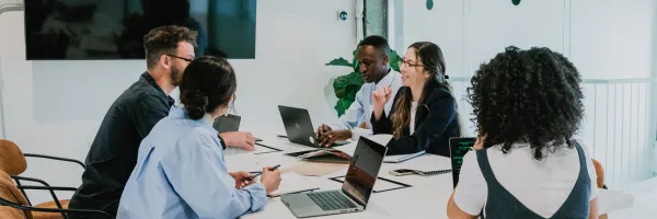 Group of business associates sitting around a table planning