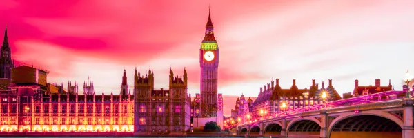 Image of the Houses of Parliament with a pink coloured skyline
