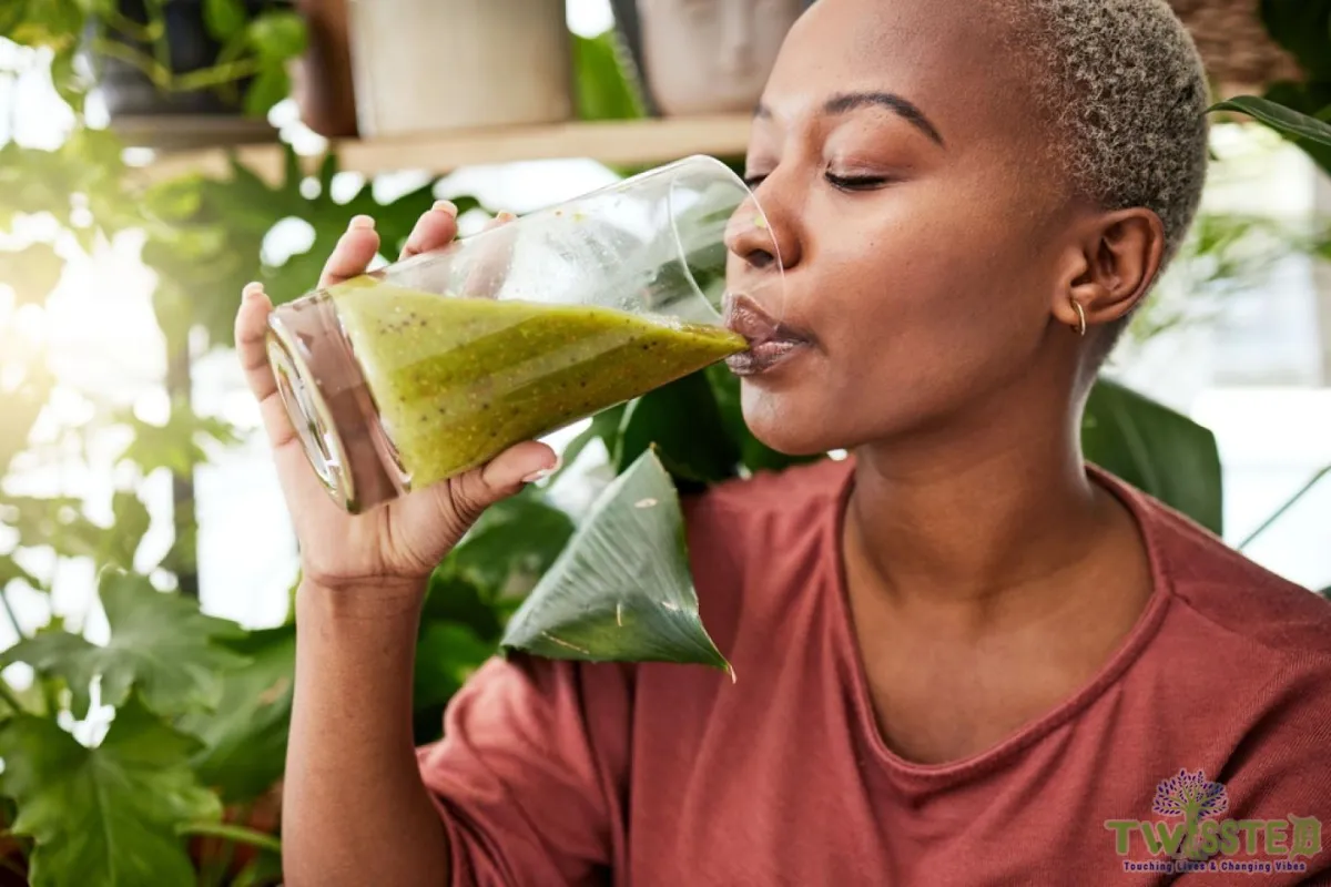 black woman drinking green juice