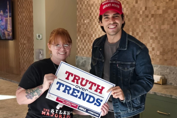 Marlon Medina, Gen Z Chairman for Turning Point Action Las Vegas, stands beside Kimmy Johnston, Field Representative for Clark County, both smiling and holding a “Truth Over Trends” sign supporting the Gen Z Conservative Coalition.