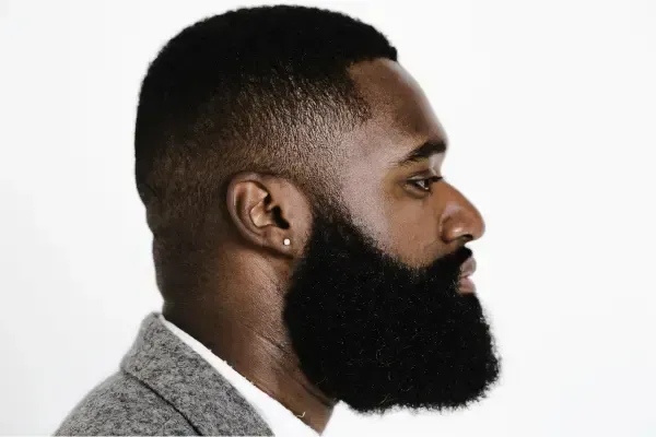 Man with a full, well-groomed beard after professional barber maintenance in Portsmouth, NH
