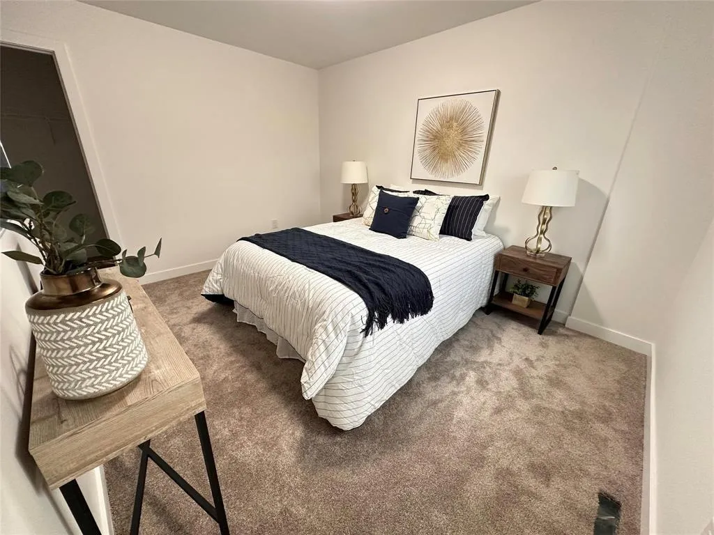 basement bedroom with finished carpeting and furniture