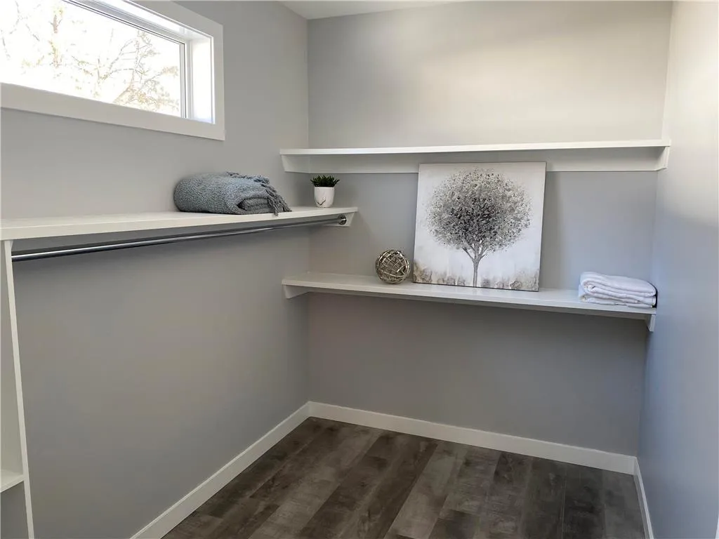 Laundry room in basement with shelving