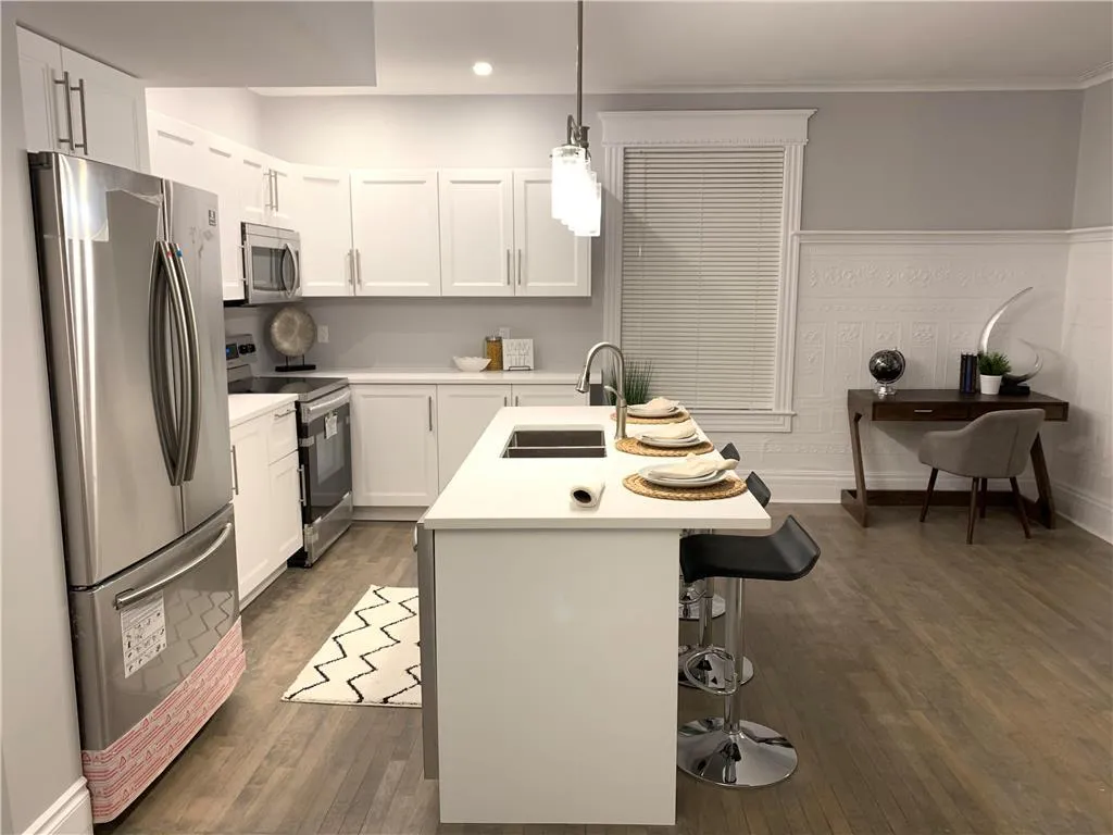 Kitchen and dining in large spaced high ceiling basement