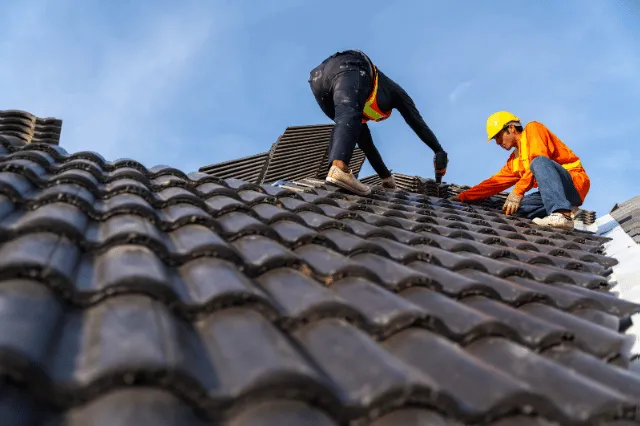2 roofers working on the working at height to install the Co