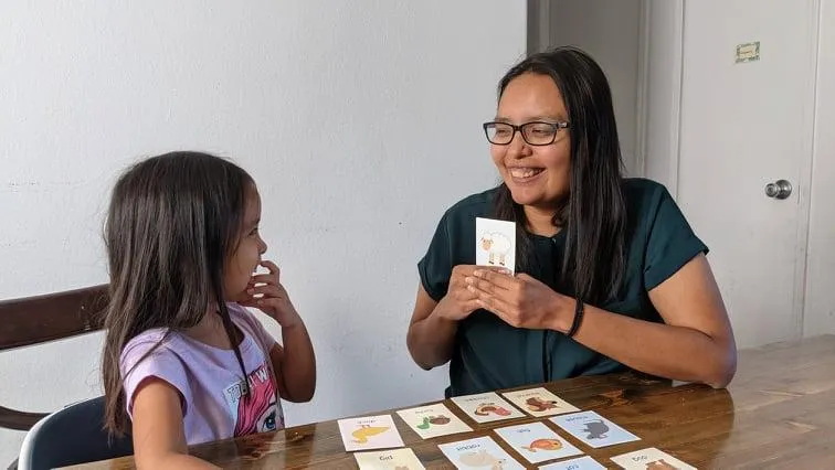 mom teaching child with flashcards