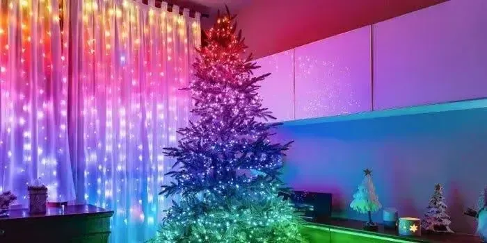 A beautifully decorated Christmas tree with colorful lights glowing in a cozy room.