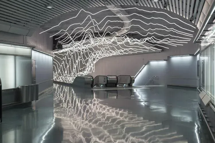 A long, illuminated hallway leading into a bright tunnel at the end.