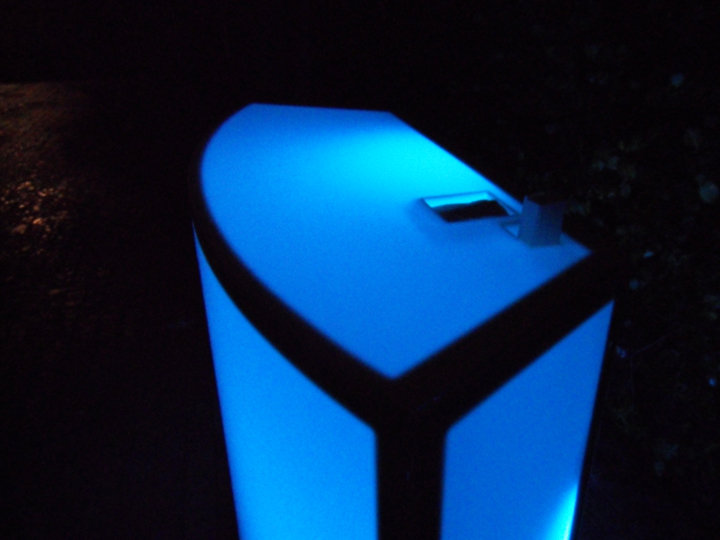 Blue illuminated bar counter at night.