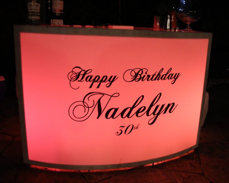Lighted bar with a “Happy Birthday Nadelyn” sign.