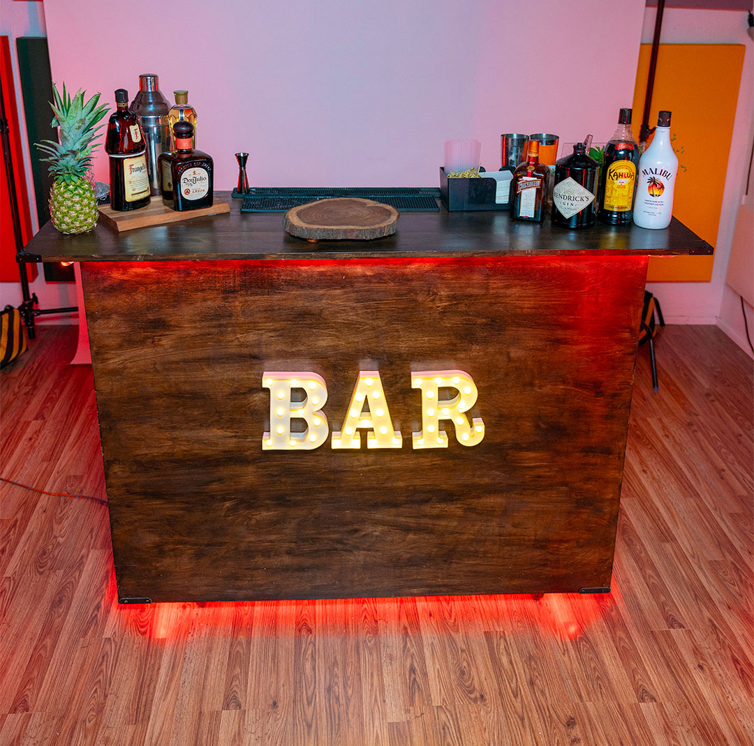 Wooden bar with illuminated BAR sign.