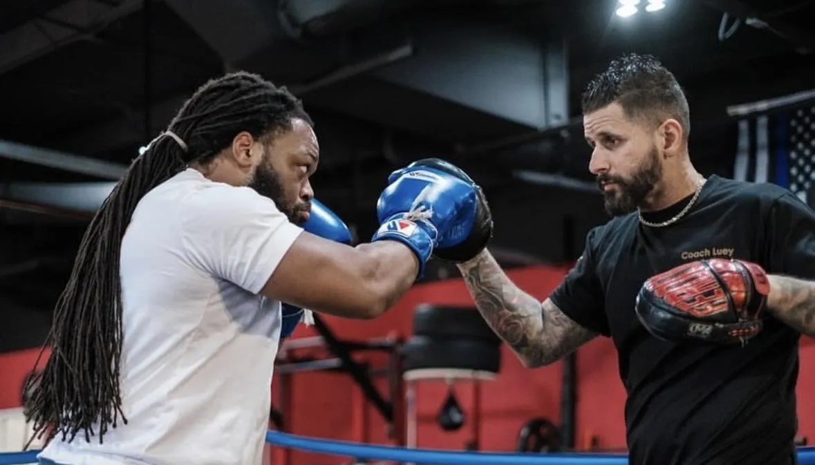 Boxing coach with student in boxing training