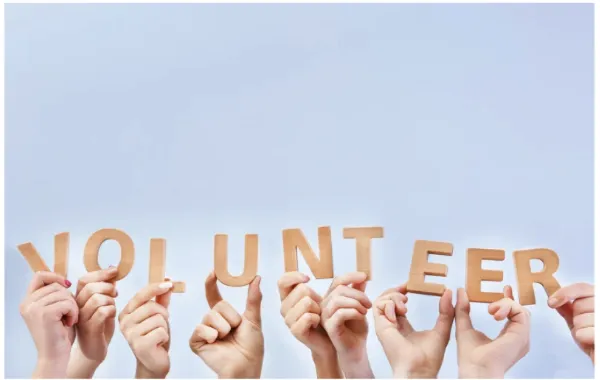 Hands holding letters that spell volunteer