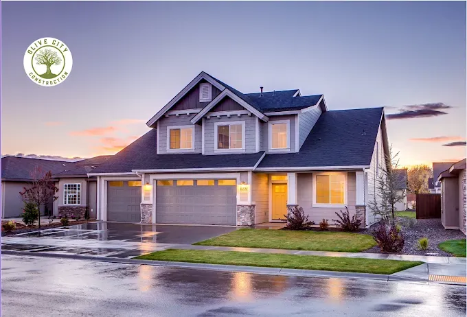 Modern two-story house with a three-car garage at sunset, built by Olive City Construction.