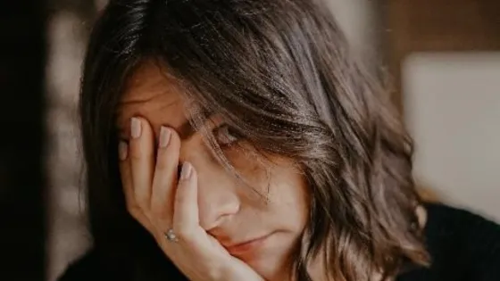 woman holding her head