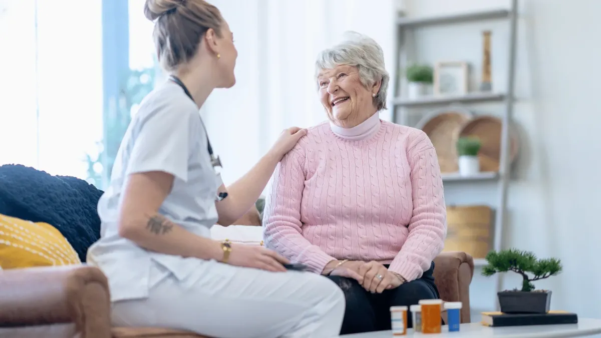 A caregiver cares for a senior in home care setting