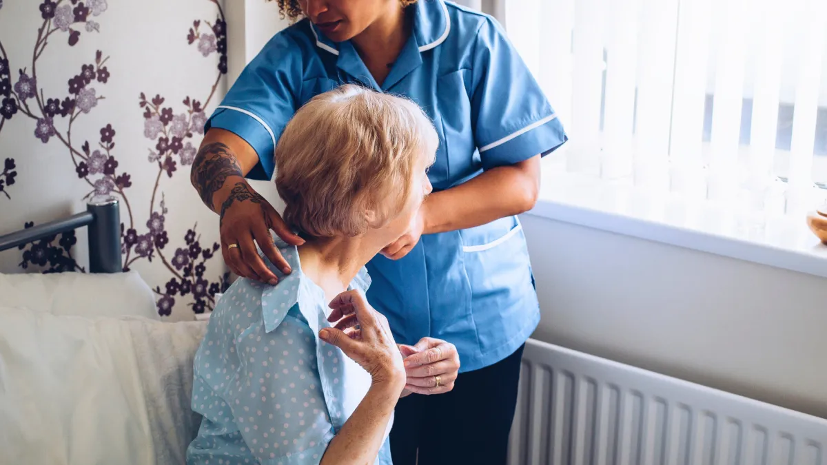Occupational therapist assisting a senior with daily living activities