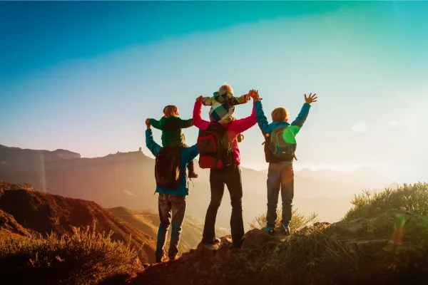 Happy Family Hiking on a hill top
