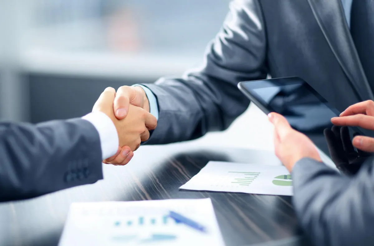 two individuals shaking hands 