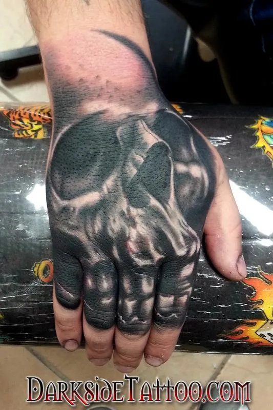 Black and Gray Skull on a Hand