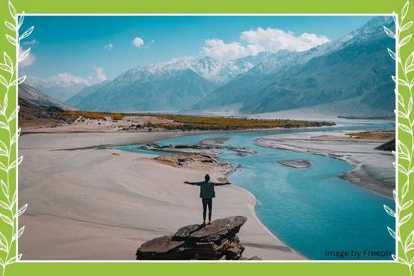 Person standing on top of mountain used in blog by Carli Thorpe