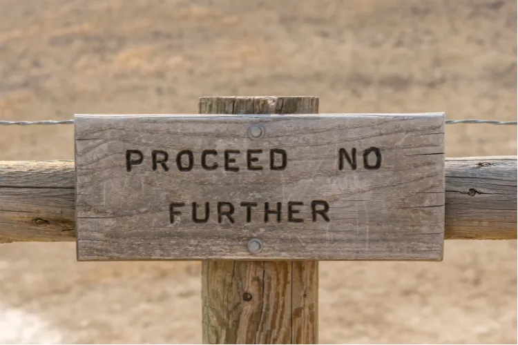Sign that says "Proceed no further"