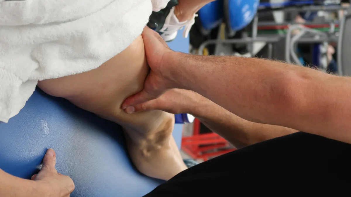 Physical therapist providing hands-on treatment to improve mobility and reduce pain.