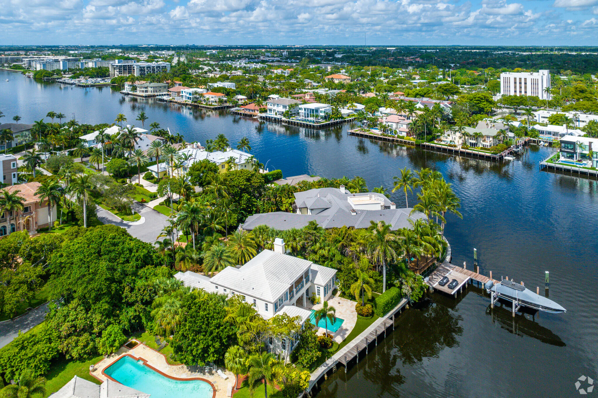 Scenic view of Delray Beach with soft white sand, turquoise water, and palm trees swaying under a bright blue sky — perfect backdrop for showcasing luxury new construction homes in Delray Beach, Florida