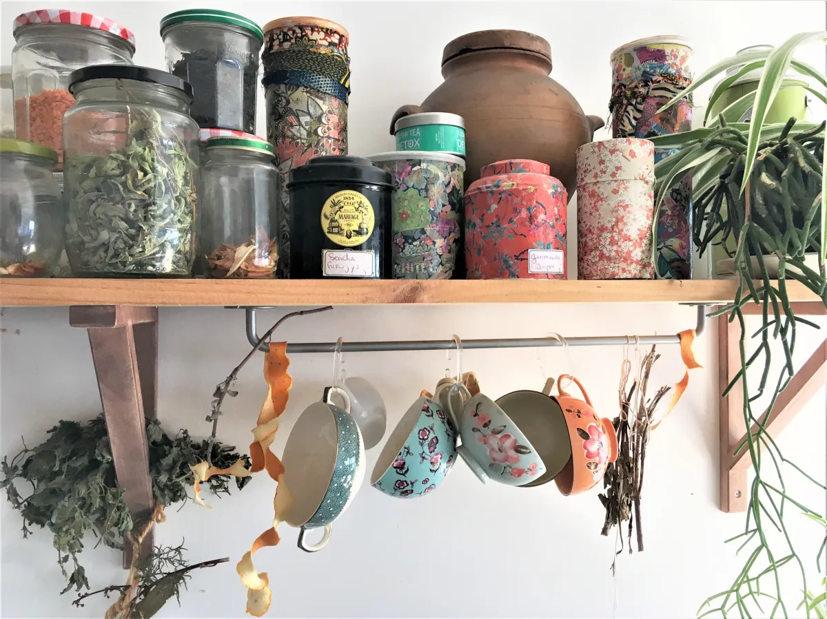 jars on a shelf filled with dried foodstuffs