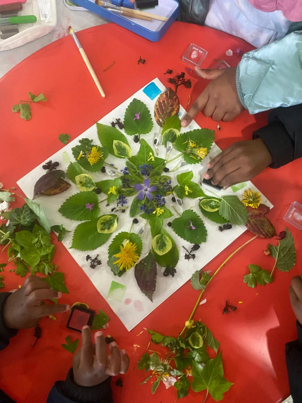 Children creating a mandala using natural found objects