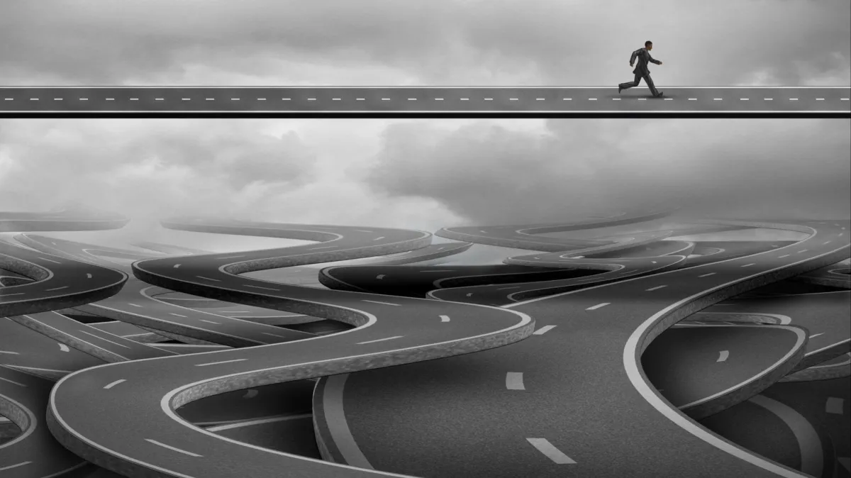 figure walking above winding roads