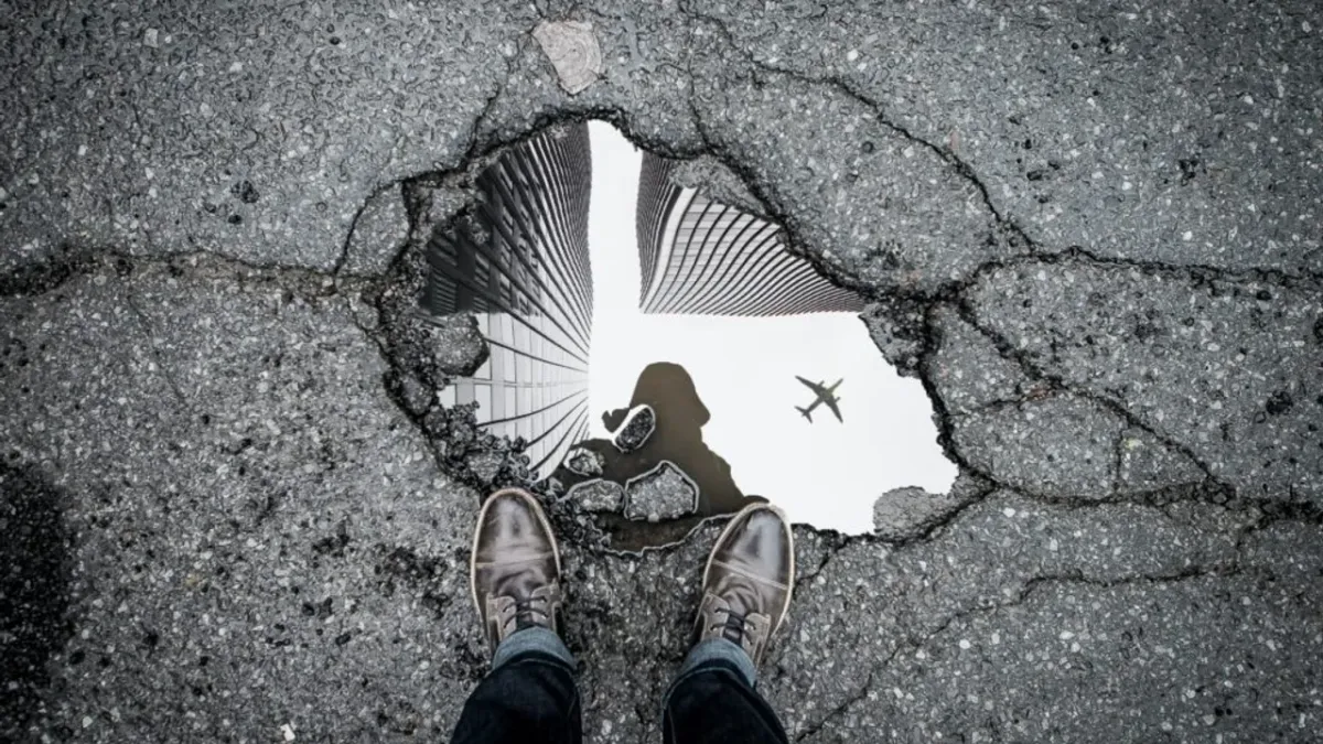 person standing in front of a hole