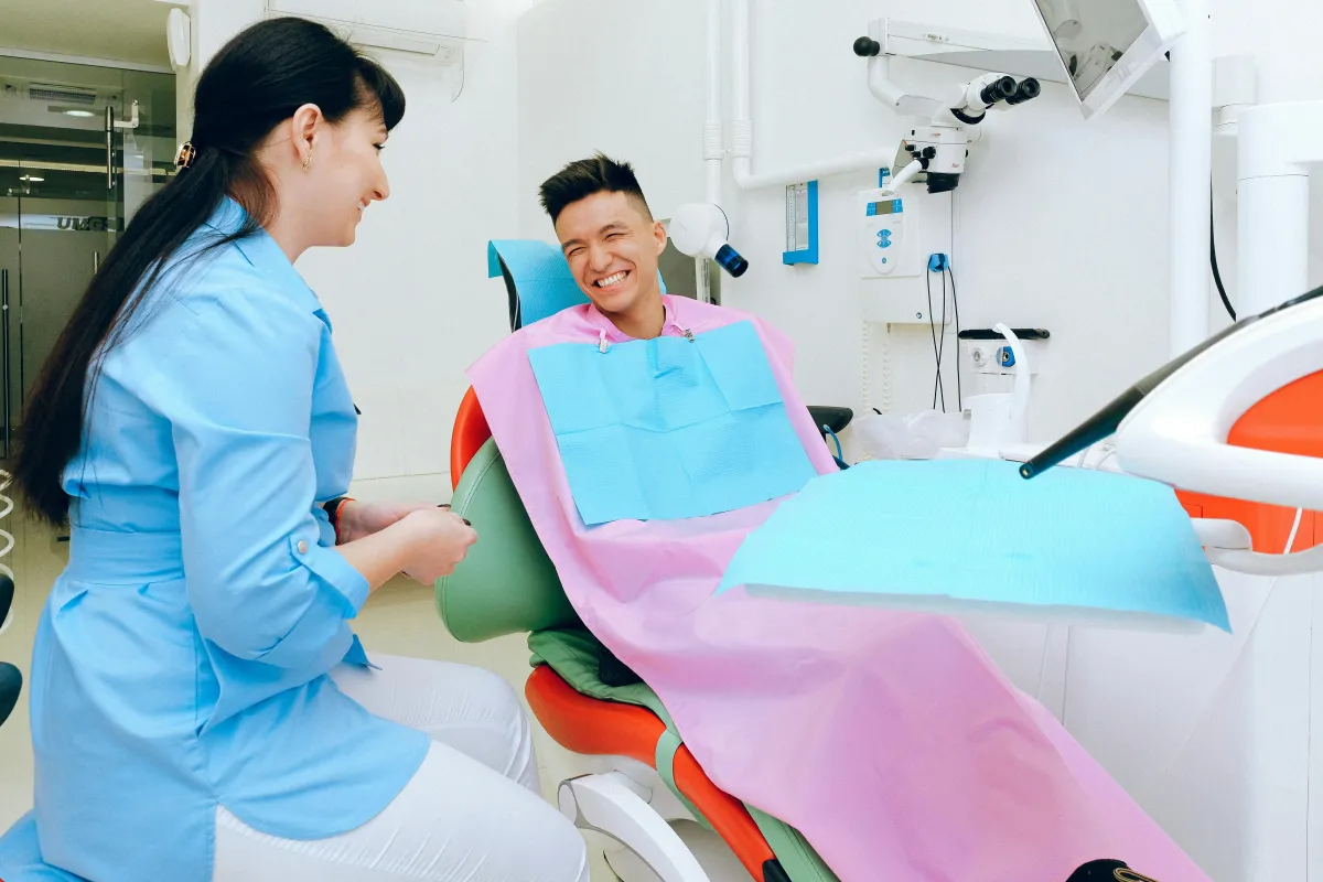 Dental hygenist and patient smiling in a dental clinic