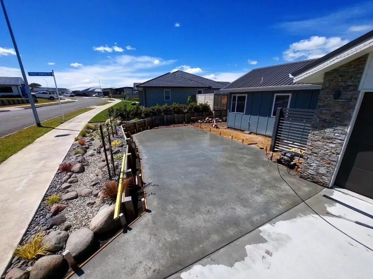 Newly installed concrete driveway in front of a modern Whanganui home with clean, sleek design.