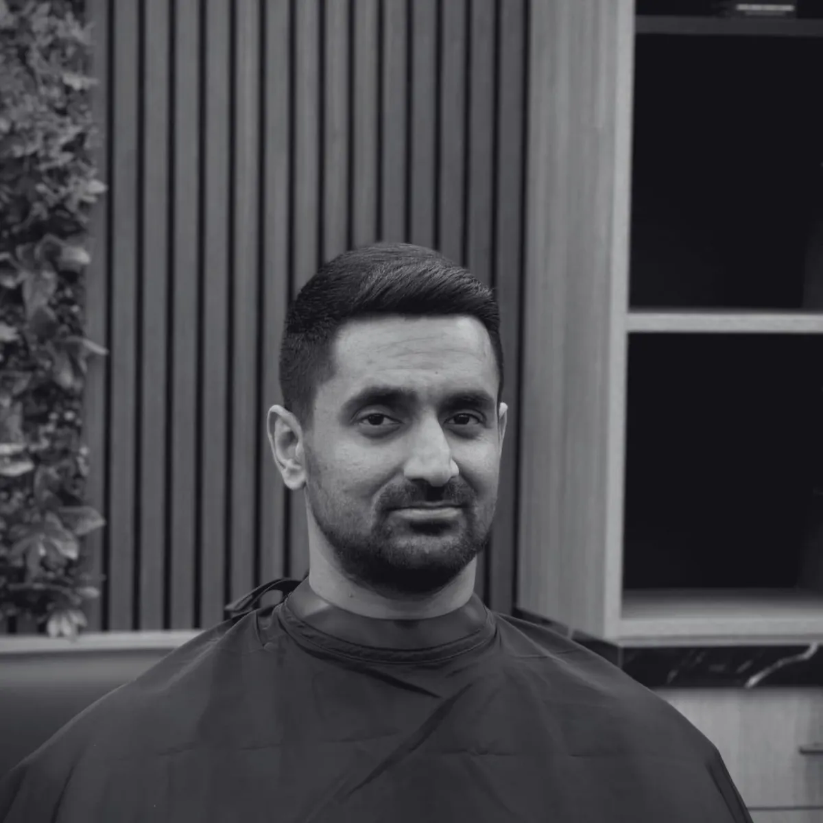 Barber applying hot towel to client’s face at Imperial Barbershop NYC