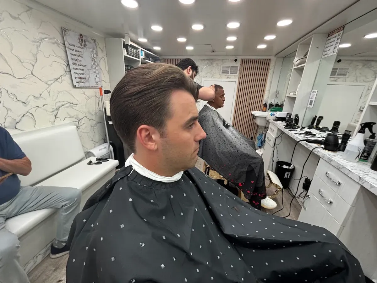 Barber giving client a fade haircut at Imperial Barbershop NYC