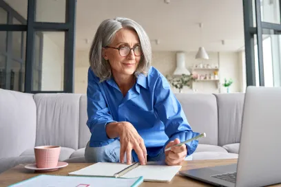 Woman Looking at laptop smiling