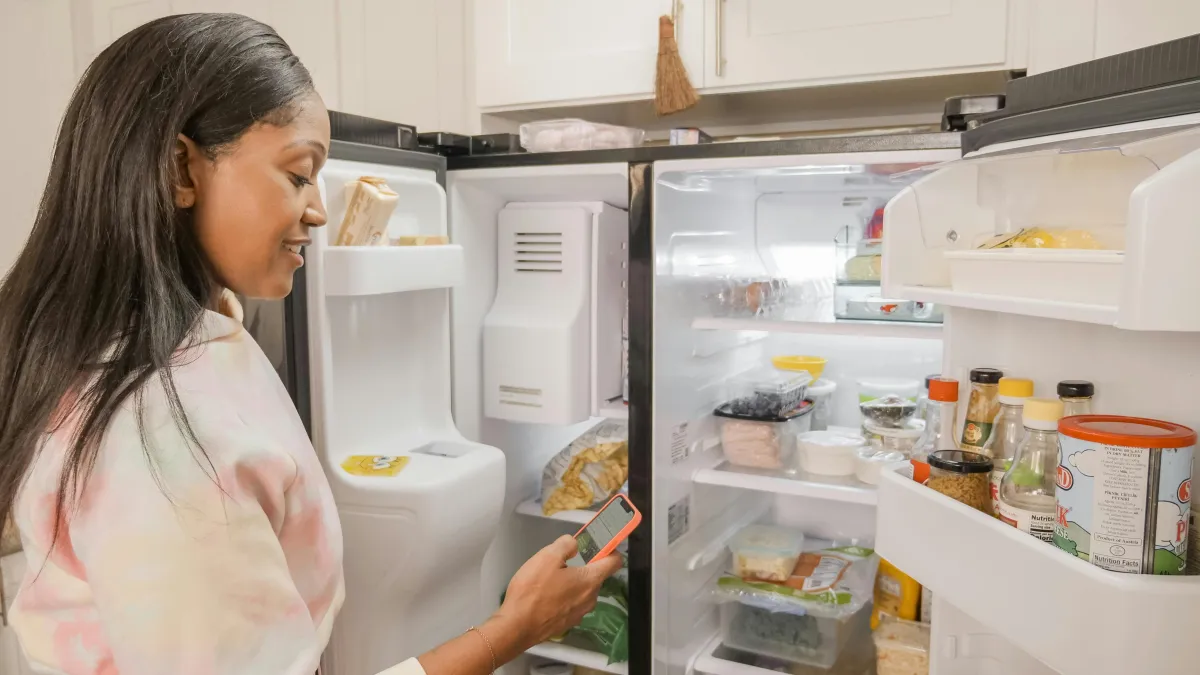 Woman looking in the fridge for food to support blog post When ADHD Makes You Hungry: Foods That Feed Focus