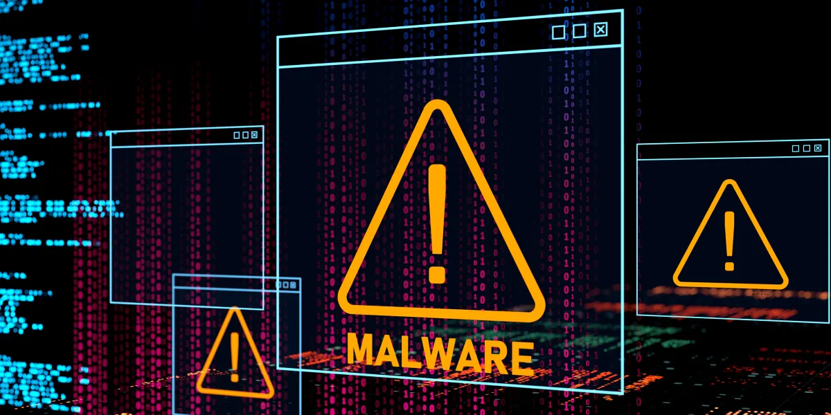 Warning alert symbol indicating a malware threat on a digital screen, with binary code background representing cybersecurity danger.