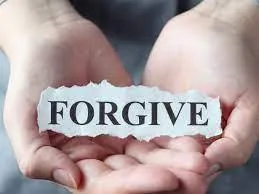 hands holding a forgive sign