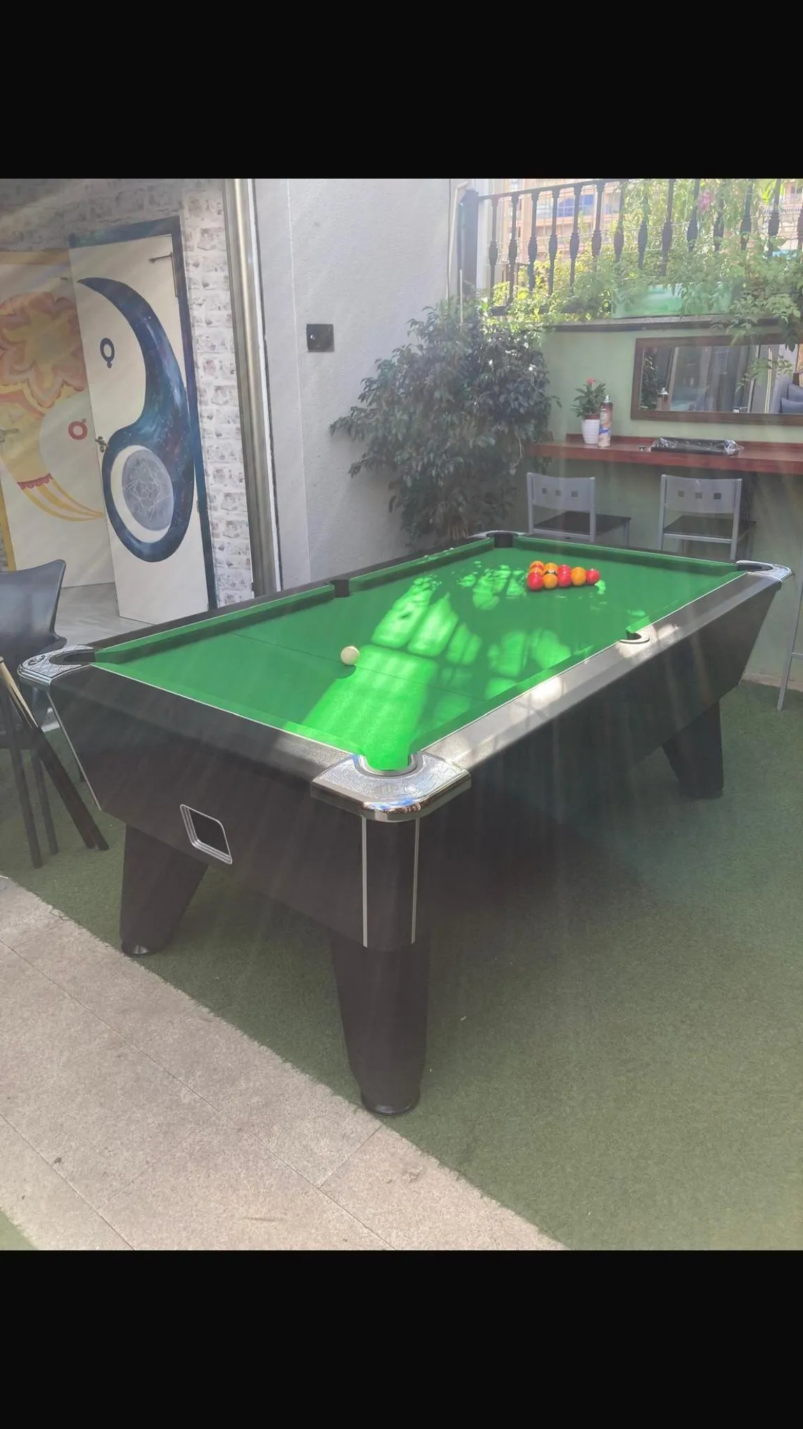 black pool table with green cloth